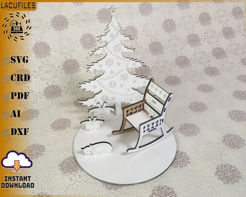 May include: A laser-cut Christmas scene featuring a tree, rocking chair, gifts, and a sleeping cat. The tree is adorned with stars and snowflakes. The chair has a decorative back with the year 2021. The base is round. The image includes the text "LACUFILES" and "INSTANT DOWNLOAD".