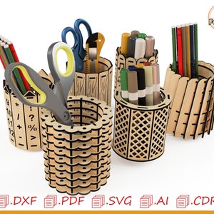 May include: Set of four laser cut wooden pencil holders. The holders are in different styles and feature geometric designs. The holders are filled with pencils, pens, and scissors.