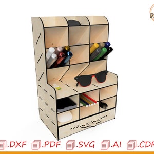 May include: A wooden desk organizer with multiple compartments for storing pens, pencils, glasses, and other office supplies. The organizer has a drawer at the bottom and a striped pattern on the front.