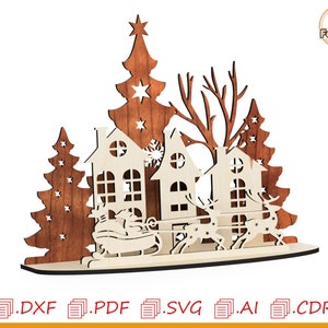 May include: A laser cut wooden Christmas scene with three houses, a Christmas tree, and two reindeer pulling a sleigh. The houses are white with brown trim and windows. The Christmas tree is brown with a star on top. The reindeer are brown with antlers. The sleigh is brown with a white seat.