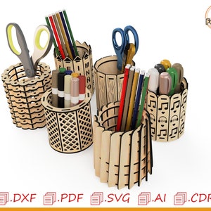 May include: Set of four wooden pencil holders with different designs. The holders are made of laser-cut wood and feature various patterns, including a fence, musical notes, and a wood grain design. The holders are filled with pens, pencils, and scissors.