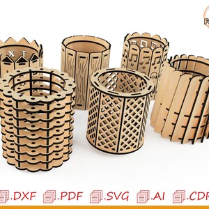 May include: Five different laser cut wooden pencil holders. The holders are all different designs, including a fence, a musical note design, a geometric pattern, and a simple wood design.