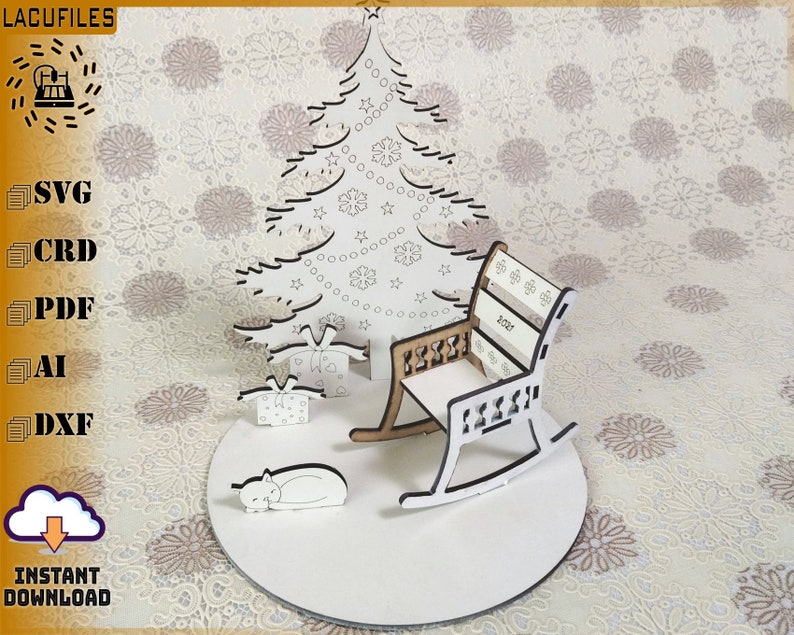 May include: A laser-cut Christmas scene featuring a tree, presents, a rocking chair, and a sleeping cat. The rocking chair has the year 2021 on the back. The scene is on a white circular base. The image also includes the text "LACUFILES" and "INSTANT DOWNLOAD".