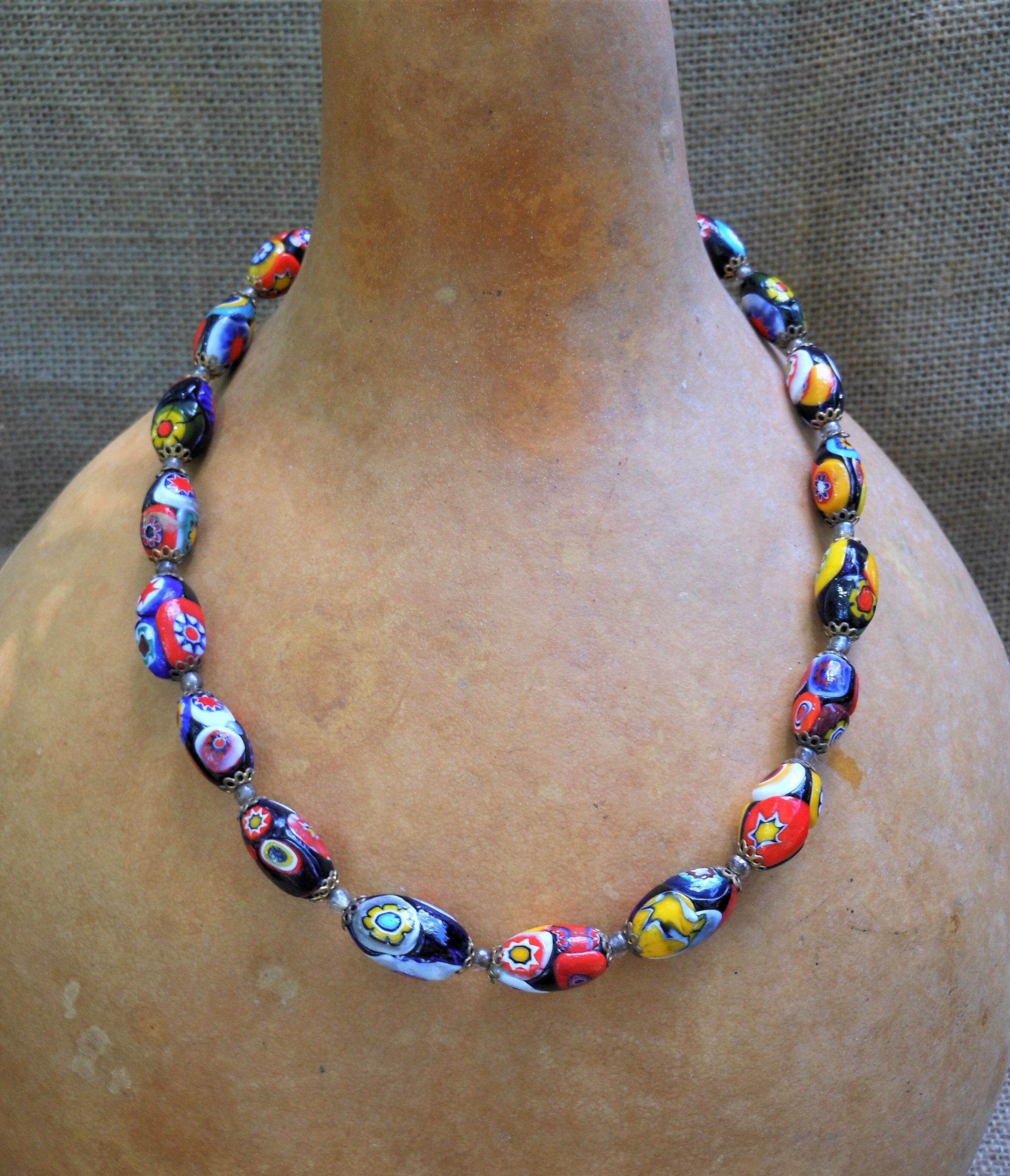string of beads (17x = .10a): 16 amber beads, 1 millefiori bead