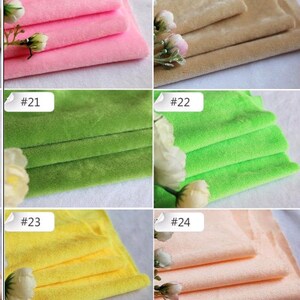 May include: Six fabric swatches in different colors, including pink, beige, green, yellow, and peach. Each swatch is folded in thirds and labeled with a number from 19 to 24.
