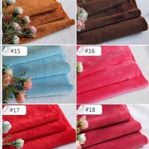 May include: Five different colors of soft, plush fabric swatches. The colors are brown, dark brown, light blue, pink, and red.