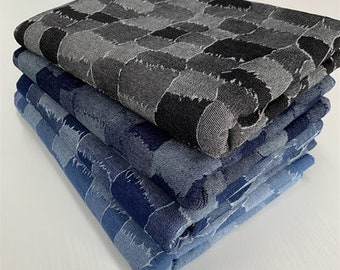 May include: A stack of five fabric swatches in various shades of blue and black. The top swatch has a geometric pattern of black and gray shapes.