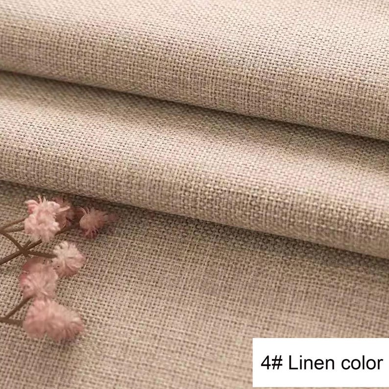 May include: A folded piece of light beige fabric with a visible woven texture. A small cluster of dried pink flowers is positioned on the lower left side. A white rectangular label in the bottom right corner displays the text 4# Linen colour.