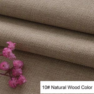 May include: A piece of tan-coloured fabric with a visible woven texture, folded to create layers. A small cluster of pink flowers is positioned on the lower left side. A white rectangular label displays the text 10# Natural Wood Color.