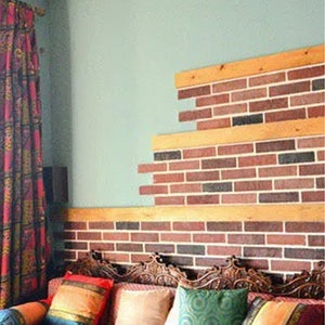 May include: A wooden couch with colorful patterned cushions and throw pillows. The couch is in front of a wall with a brick pattern made from faux brick panels.