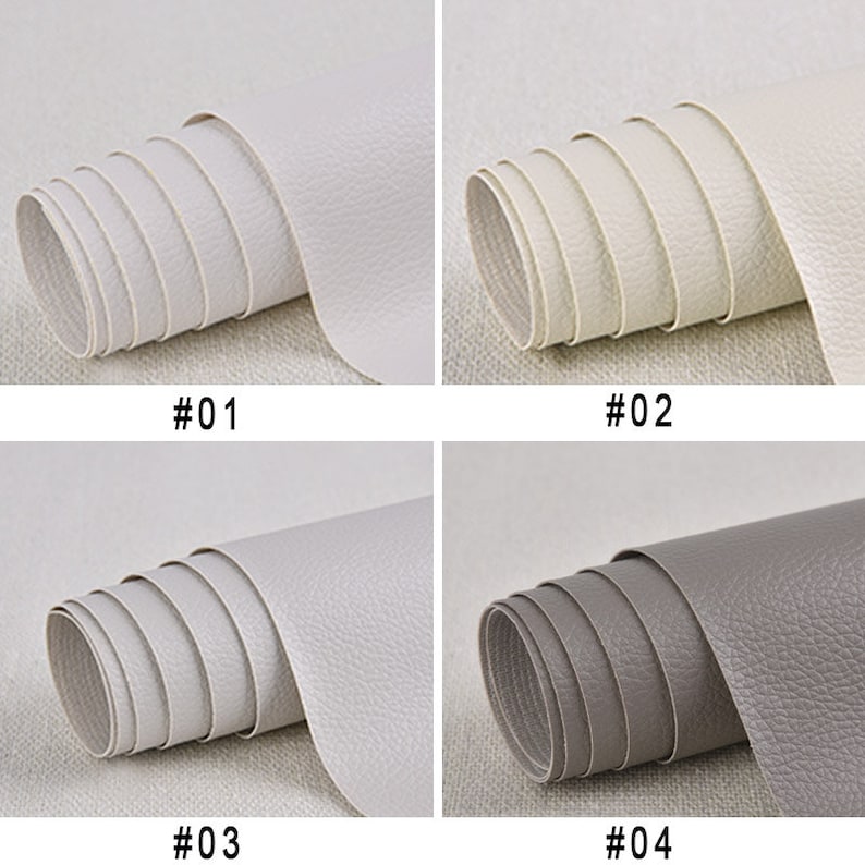 Puede incluir: Cuatro rollos de piel sint&eacute;tica en diferentes colores. El primer rollo es blanco, el segundo es blanquecino, el tercero es gris claro y el cuarto es gris. Cada rollo est&aacute; etiquetado con un n&uacute;mero del 1 al 4.