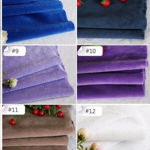 May include: Close-up of 6 different fabric swatches in various colors, including blue, purple, and brown. The swatches are folded and arranged in a grid pattern. Each swatch is labeled with a number.