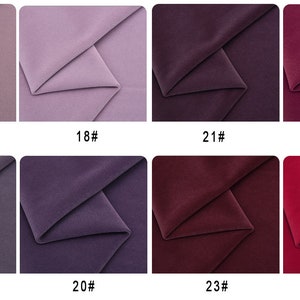 May include: Eight fabric swatches in various shades of purple, pink, and red. The swatches are arranged in two rows of four, with each swatch labeled with a number.