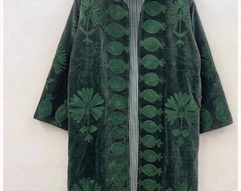 May include: A long, dark green velvet coat featuring intricate, tonal green floral and botanical embroidery. The garment has a high collar, long sleeves, and an open front that reveals a white and dark green vertical striped lining throughout.