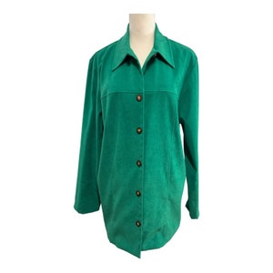 May include: A green button-down jacket with long sleeves. The jacket has a collared neckline and is fastened with six brown buttons. The fabric appears to be a soft, textured material. The jacket is displayed on a mannequin.