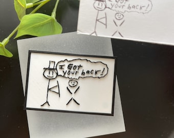 May include: A white rectangular sign with a black border features a stick figure wearing a top hat and the phrase "I got your back!" in a speech bubble. A second, similar drawing is visible in the background.