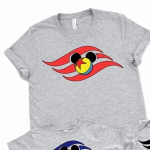 May include: Set of five grey t-shirts featuring a red, blue and yellow Mickey Mouse head with a red, blue and yellow wave design. The shirts are in different sizes for adults and children.