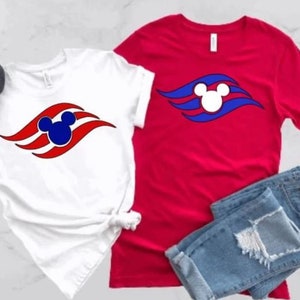 May include: Two t-shirts featuring a red, white and blue Mickey Mouse head logo. The logo is a stylised wave with a Mickey Mouse head in the centre. One shirt is white and the other is red.