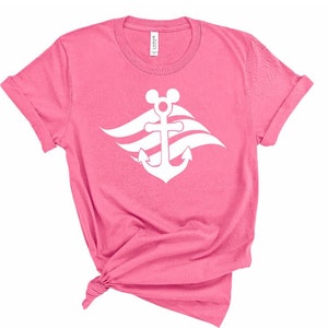 May include: Pink t-shirt with a white anchor and Mickey Mouse ears. The anchor has three waves behind it.