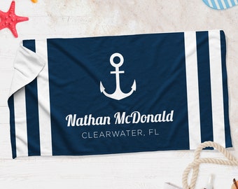 May include: A blue and white beach towel with a white anchor and the text "Nathan McDonald CLEARWATER, FL".