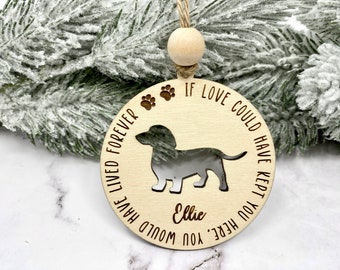 May include: A wooden Christmas ornament with a dachshund silhouette, paw prints, and the text "If love could have kept you here, you would have lived forever." The ornament is personalized with the name "Ellie".