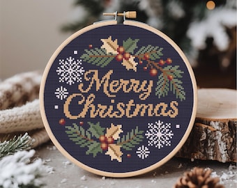 May include: A circular wooden embroidery hoop containing a cross-stitch design on dark fabric. The text Merry Christmas is stitched in tan thread, surrounded by green holly leaves, red berries, and white snowflakes on a dark blue background.