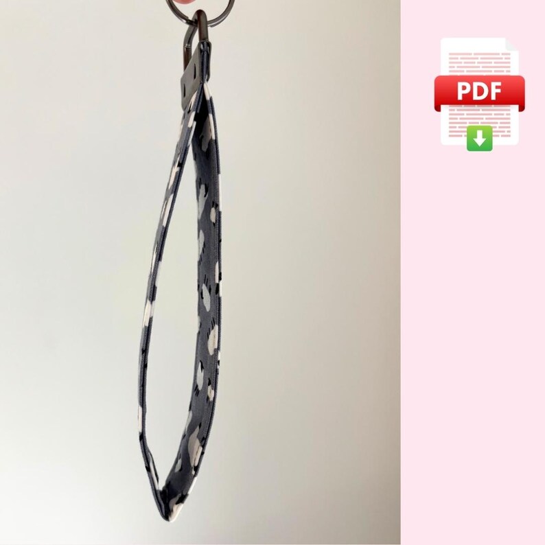 May include: A black and white patterned key chain with a silver key ring.