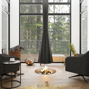 May include: Two black swivel chairs face a modern fireplace with a black metal chimney and a round fire pit. The fireplace is in the centre of a room with large windows overlooking a forest.