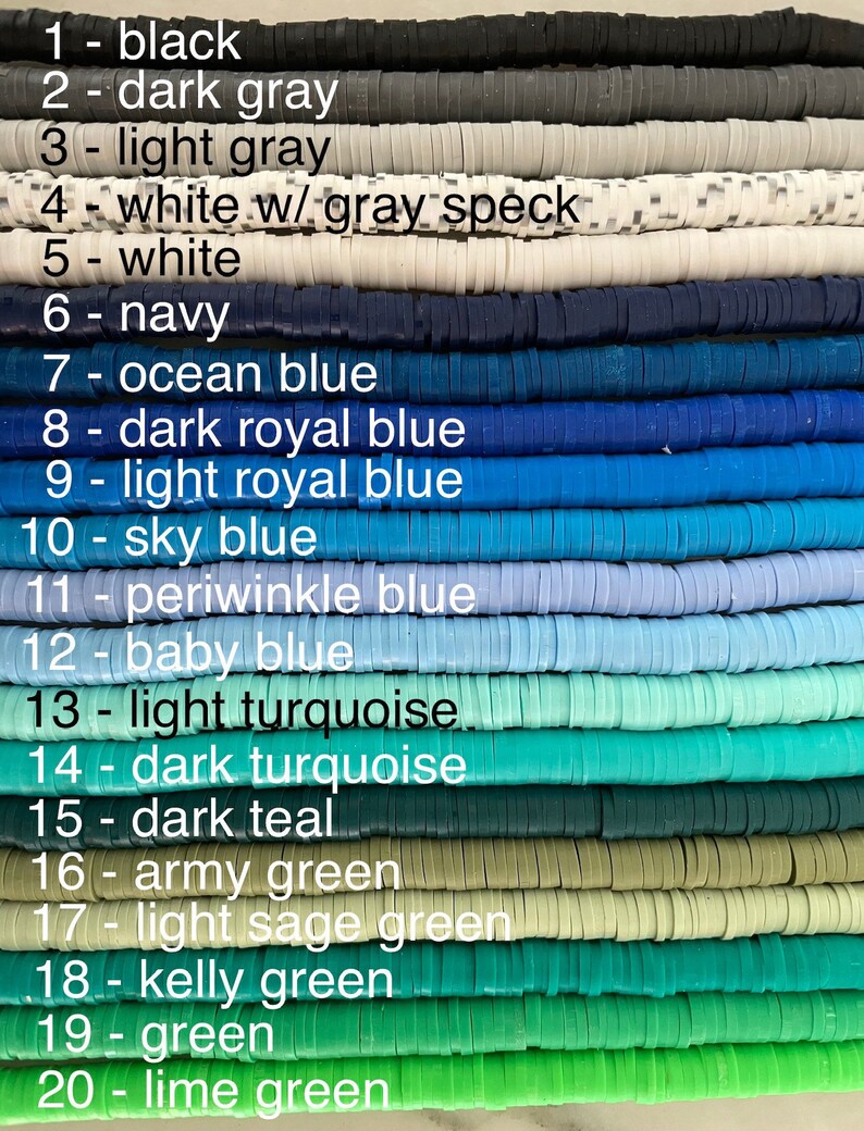 May include: A close-up of 20 rows of colourful polymer clay beads. The beads are arranged in rows from black to lime green. Each row is labelled with a number and the colour name. The beads are all the same size and shape.