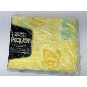 May include: A yellow and white double flat sheet with a butterfly pattern. The sheet is packaged in plastic and has a label that reads "No-Iron Percale Pequot 45% Dacron Polyester 35% Cotton/Coton Double Flat Sheet for 54x76 in. Mattress (81x104 in. Before Trimming)"