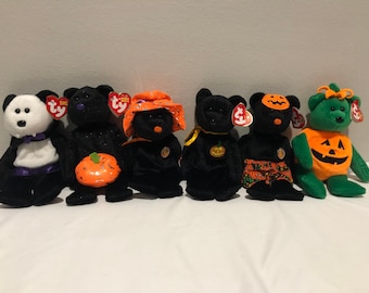 May include: Six Halloween themed beanie baby plush toys. The toys are a black bear with a pumpkin, a black bear with a witch hat, a black bear with a pumpkin, a black bear with a pumpkin and a jack-o-lantern face, a green bear with a pumpkin and a jack-o-lantern face, and a black and white panda bear with a purple bow.