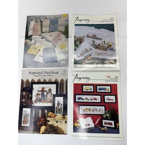 May include: Four cross-stitch pattern books. The covers feature images of finished needlework projects, including towels, garden scenes, and trucks. Titles include "Powder Room Pastels," "Favorite Patterns," "Harvest Festival," and "I Love Trucks."