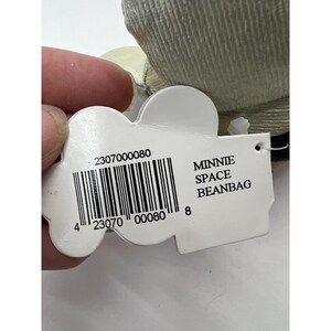 May include: White Minnie Mouse Space Beanbag with a white tag that says "Minnie Space Beanbag" and has a barcode with the number 2307000080.