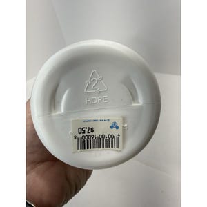 May include: A white plastic bottle with the text "HDPE" and a recycling symbol on the bottom. A sticker with a barcode and the text "The Walt Disney Company" is also visible.