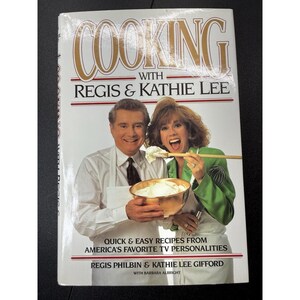 May include: A cookbook titled "Cooking with Regis & Kathie Lee" features a photo of Regis Philbin and Kathie Lee Gifford. The cover includes the text "Quick & Easy Recipes from America's Favorite TV Personalities."