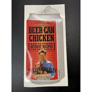 May include: A rectangular sticker shaped like a beer can featuring the cookbook cover for Beer-Can Chicken by Steven Raichlen. The design includes bold red and black text, a photograph of the author holding a roasted chicken, and a list of recipes.