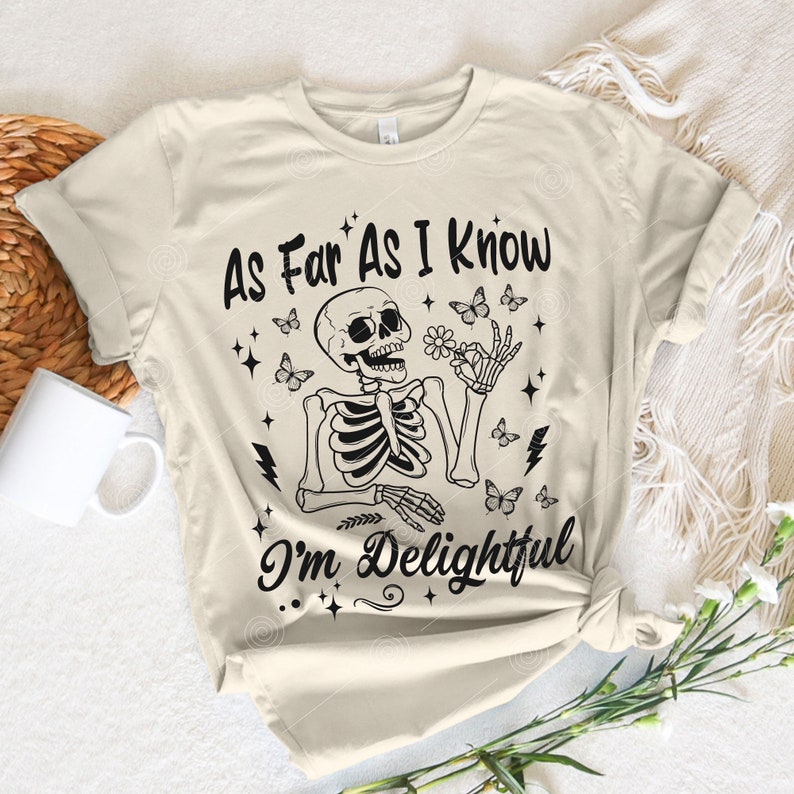 May include: A beige t-shirt with a black skeleton graphic and the text "As Far As I Know I'm Delightful".