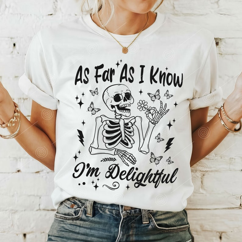 May include: White t-shirt with a black skeleton graphic holding a flower and butterflies. The text "As Far As I Know I'm Delightful" is printed on the shirt.