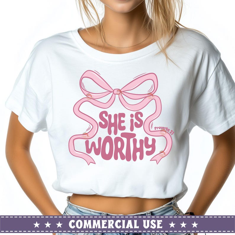 May include: White t-shirt with a pink bow and the text "She is worthy" with "Proverbs 31" in smaller text below.