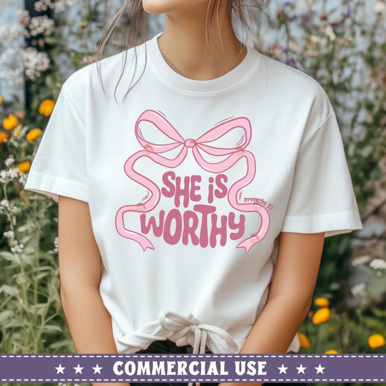 May include: White t-shirt with a pink bow and the text "She is worthy" with the Bible verse "Proverbs 31" underneath.