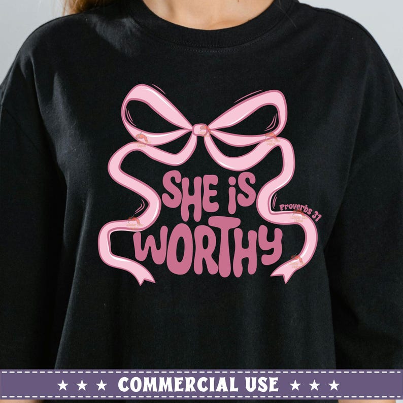 May include: Black t-shirt with a pink bow and the text "She is worthy" with "Proverbs 31" in smaller text below the bow.