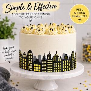 May include: A round cake with white frosting, topped with piped cream swirls and black and yellow sprinkles. A black and yellow city skyline silhouette wrap is applied to the base. Text reads: Simple & Effective, ADD THE PERFECT FINISH TO YOUR CAKE, PEEL & STICK IN MINUTES, Looks great on buttercream, fondant or ganache!