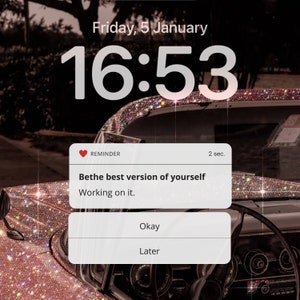May include: A pink and white phone screen with a reminder notification that says "Bethe best version of yourself. Working on it." The time is 16:53 and the date is Friday, 5 January.