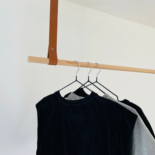 Coat rack made of beech wood with brown leather straps