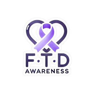 May include: A sticker featuring a purple ribbon over a heart-shaped design. The letters "F.T.D" are below the heart, with the word "AWARENESS" underneath. The design is in shades of purple and white.