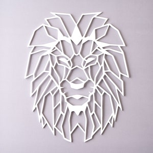 May include: White geometric lion head wall decor. The lion's mane is made up of many triangles and lines.