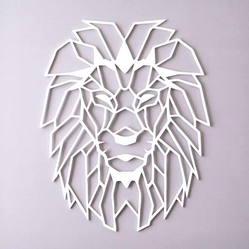 May include: White geometric lion head wall decor. The lion's mane is made up of many triangles and lines.