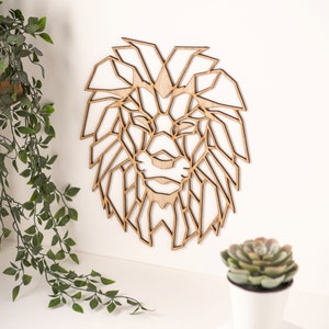 May include: Geometric wooden lion head wall decor. The lion's mane is made up of intricate geometric shapes, creating a modern and stylish design.