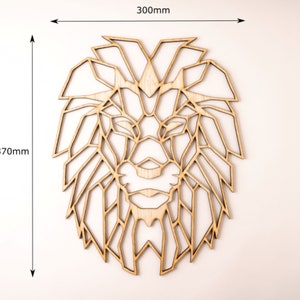 May include: Geometric wooden lion head wall art, measuring 12 inches by 12 inches. The lion's mane and face are made up of intricate geometric shapes.