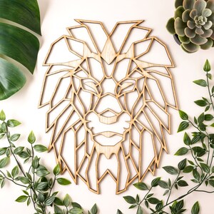 May include: Geometric wooden lion head wall decor. The lion's mane is made up of intricate geometric shapes, creating a modern and stylish design.